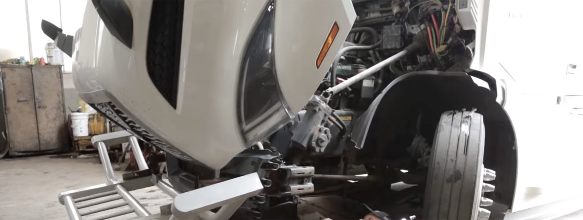 Truck in repair shop with hood open